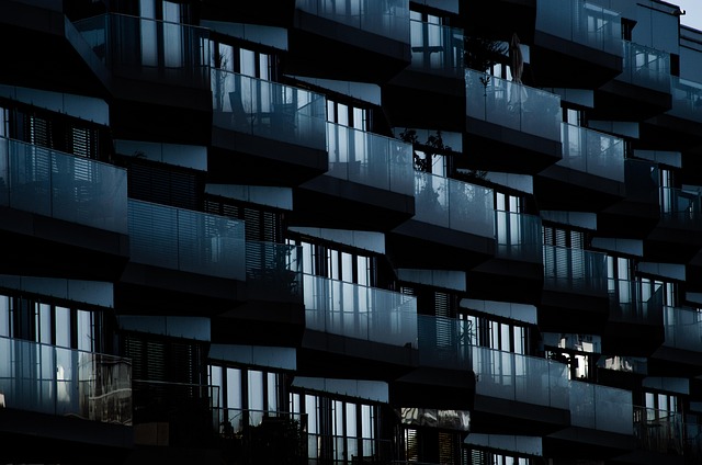 wooden window box planter with radishes and spring onions growing on an apartment balcony railing